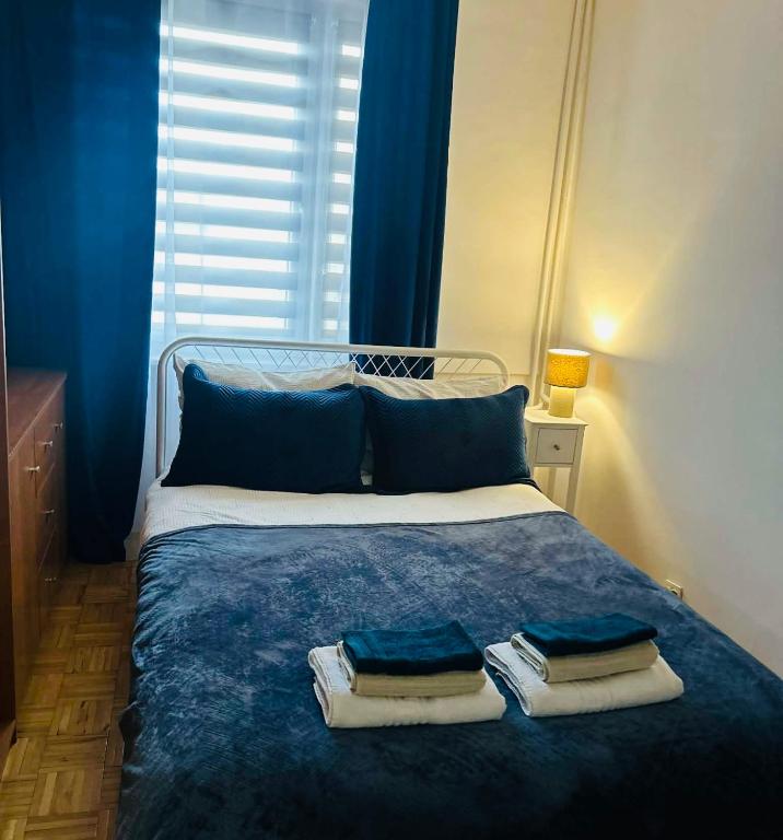 a bed with three towels on top of it at Włocławek Norwida in Włocławek