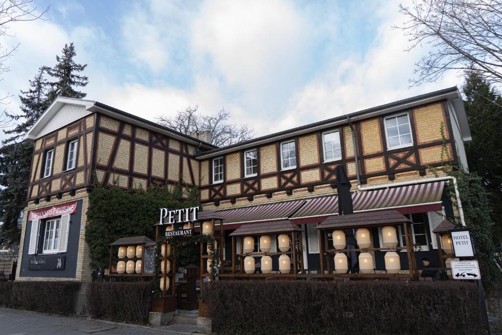 a large building with a sign in front of it at Petit Wannsee GmbH in Berlin
