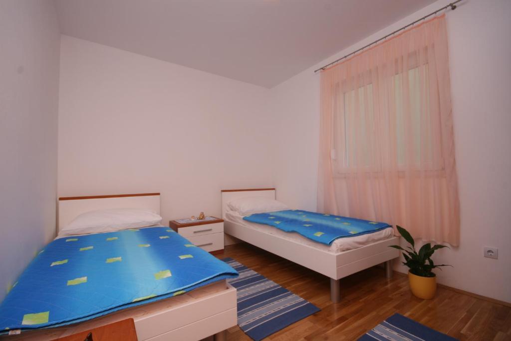 Posteľ alebo postele v izbe v ubytovaní Apartments Beverly