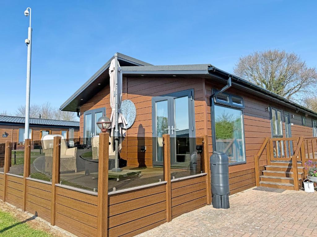 a house with a large window and a deck at Staying Inn in West Mersea