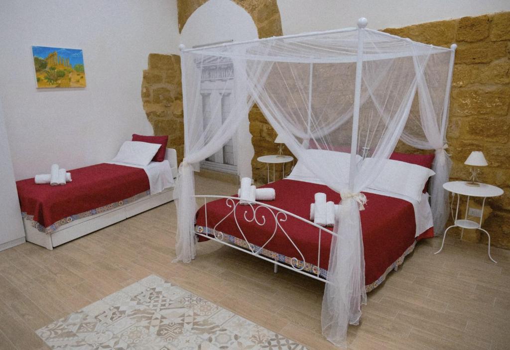 a bedroom with two beds and a canopy at Anima Templi in Agrigento