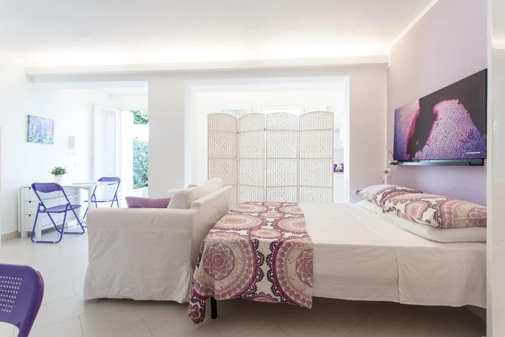 A bed or beds in a room at Mondello Suites FLH - Gorgonia