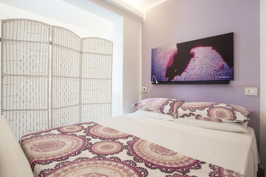 A bed or beds in a room at Mondello Suites FLH - Gorgonia