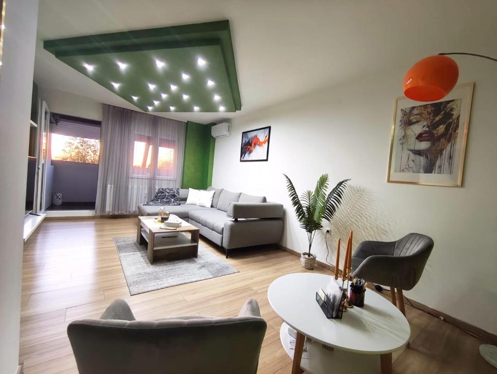 a living room with a couch and a table at Apartment Aby - Free Parking & Self Check-in in Slavonski Brod