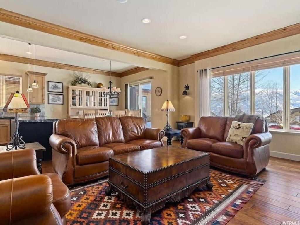 a living room with leather couches and a table at Powder Mtn Wolf Den TR11Mtn Biking Dog Friendly in Eden