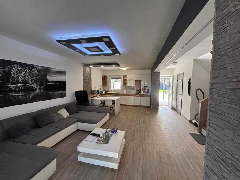 a living room with a couch and a table at LUX Pool Villa Zamárdi in Zamárdi