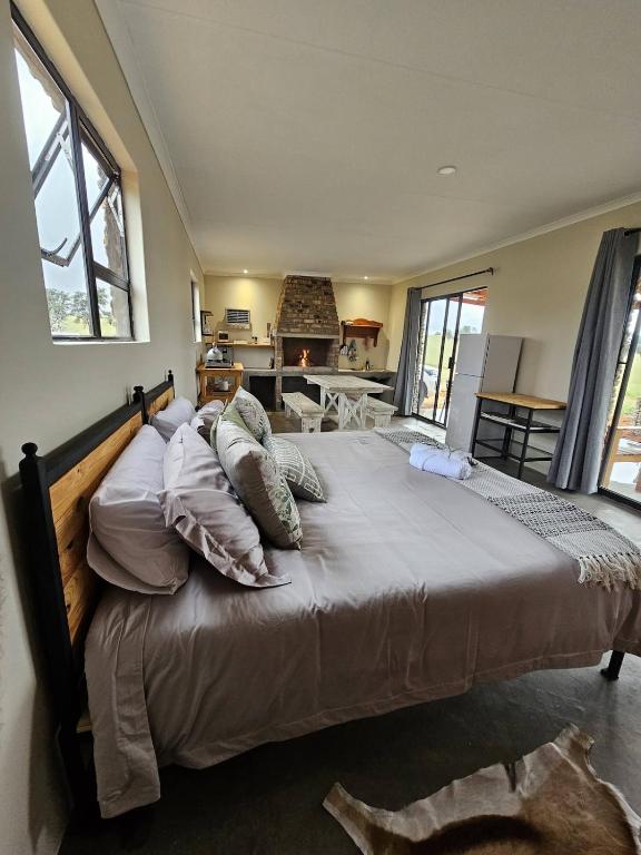a bedroom with a large bed with pillows at Troupant - Luxury Bush Unit in Askham