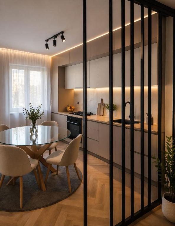 a kitchen and dining room with a table and chairs at Apartament by DANIA&PETRU in Târgu Ocna