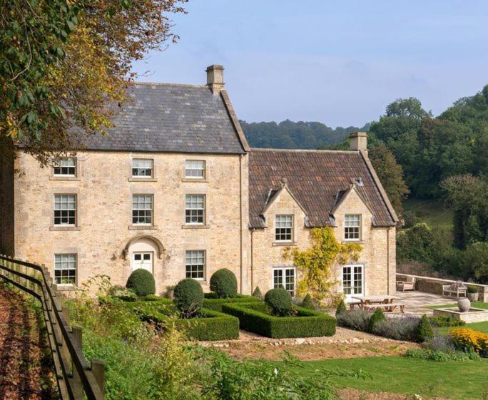 a large brick house with a garden in front of it at Week Farm Manor in Wellow