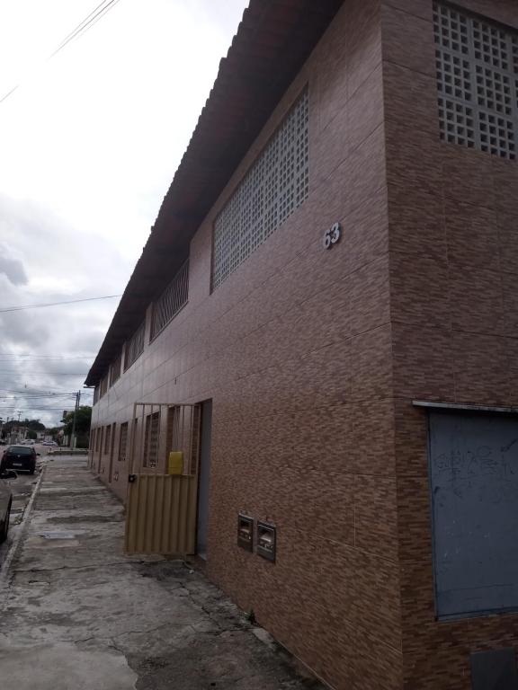 a brick building with a door on the side of it at Apartamento in Parnamirim
