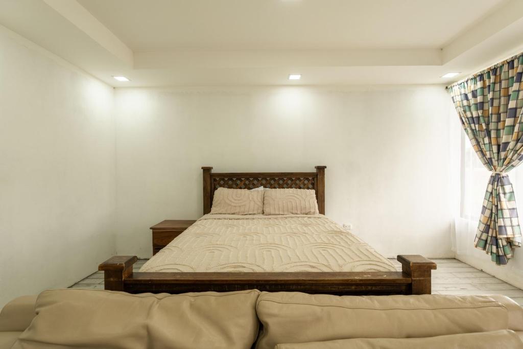 a bedroom with a large bed in a room at Catalinas Cozy Room in Fortuna