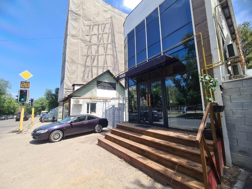 a car parked in front of a building at Corps-A in Almaty