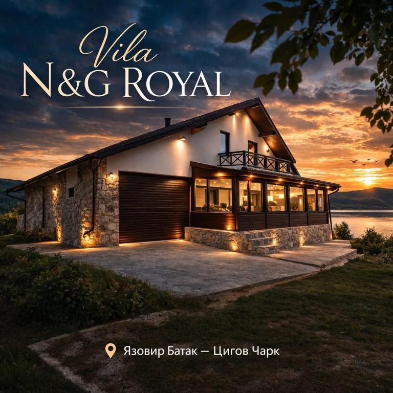 a house with lights in front of a sunset at ng royal in Rakitovo