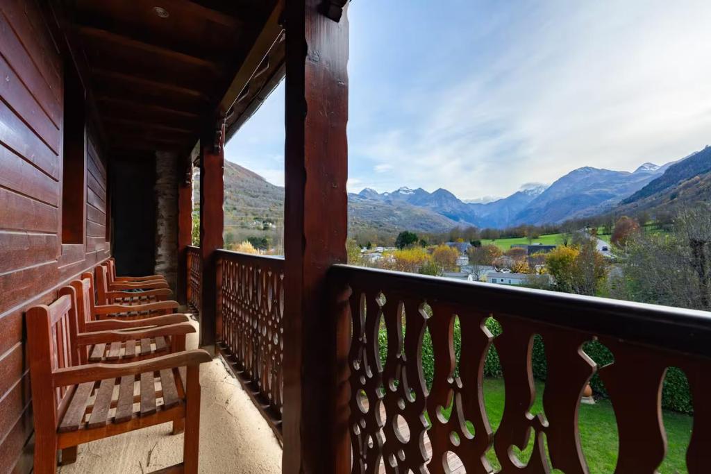 a balcony with chairs and a view of mountains at L'Ancienne Poste Exclusive Alpine Chalet in Avajan
