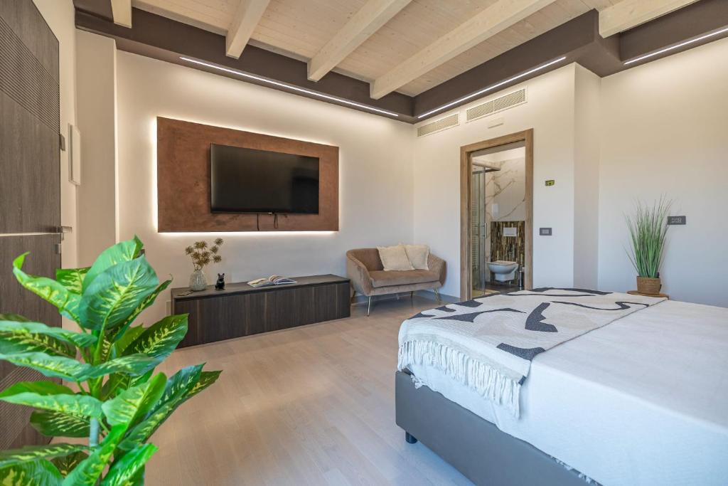 a bedroom with a bed and a flat screen tv at Alfiri 890 in Santa Maria Pietrafitta