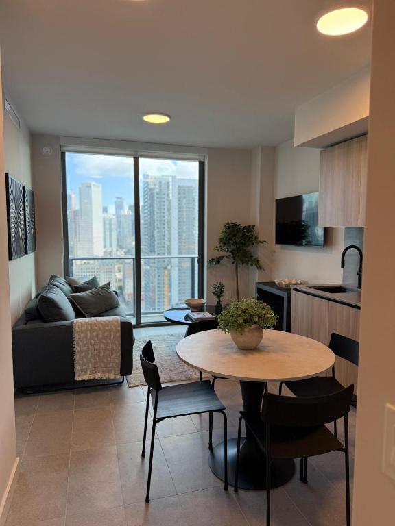 a kitchen and living room with a table and a couch at 501 First Residences Miami in Miami