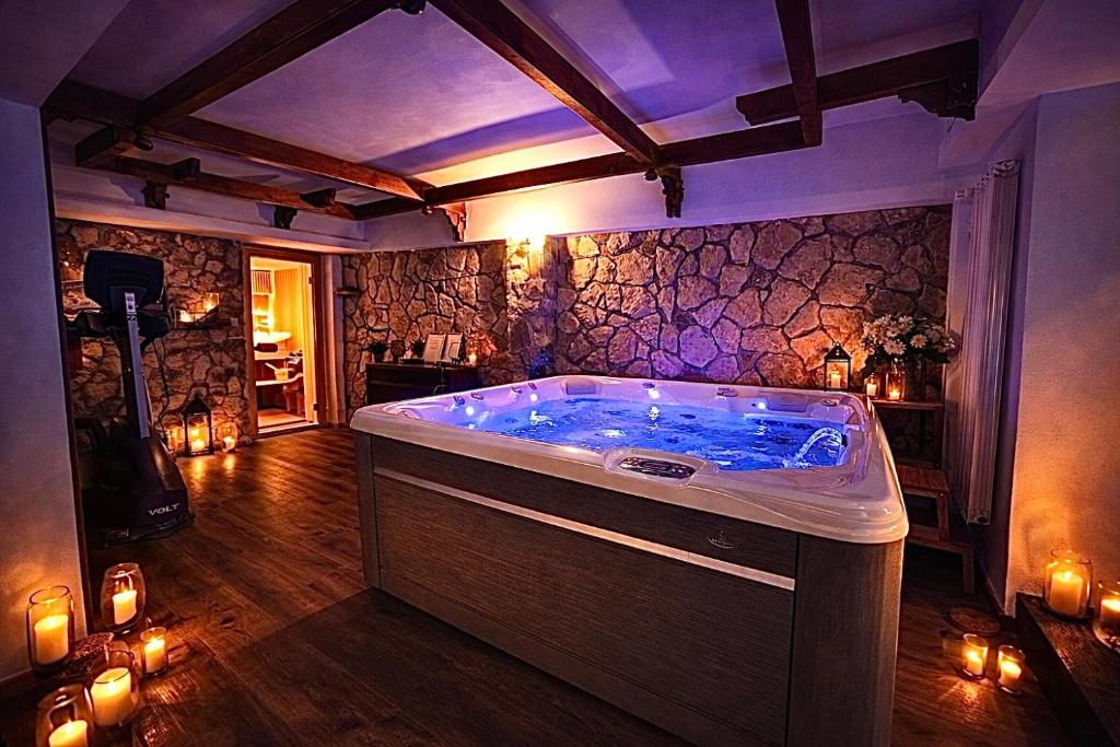 a jacuzzi tub in a room with candles at No107 Predeal in Predeal