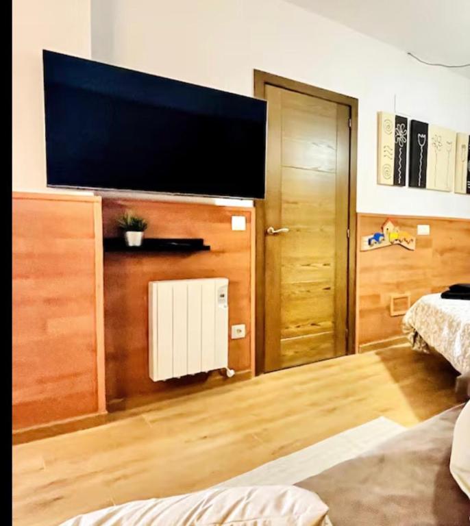 a living room with a flat screen tv on a wall at Estavar in Estavar