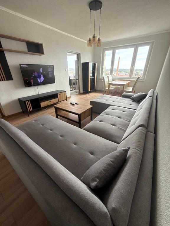 a living room with a couch and a tv at Apartment Centrum in Lučenec