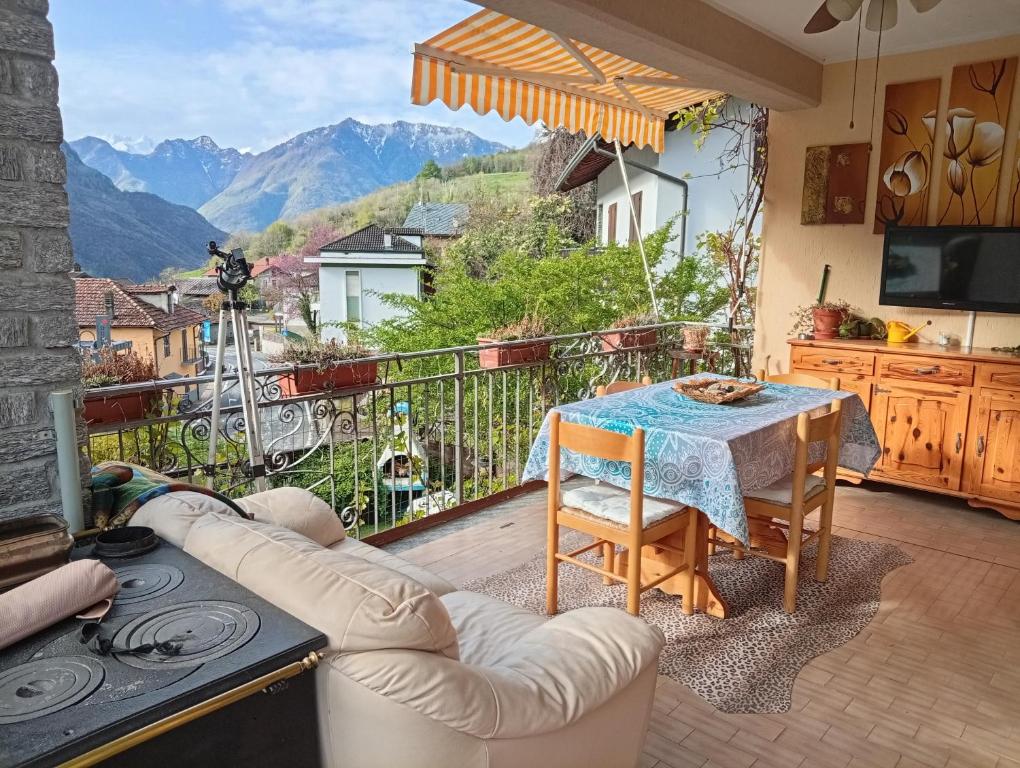 a living room with a table and a view of mountains at Remig Ranch CIR 0001 in Challand Saint Victor