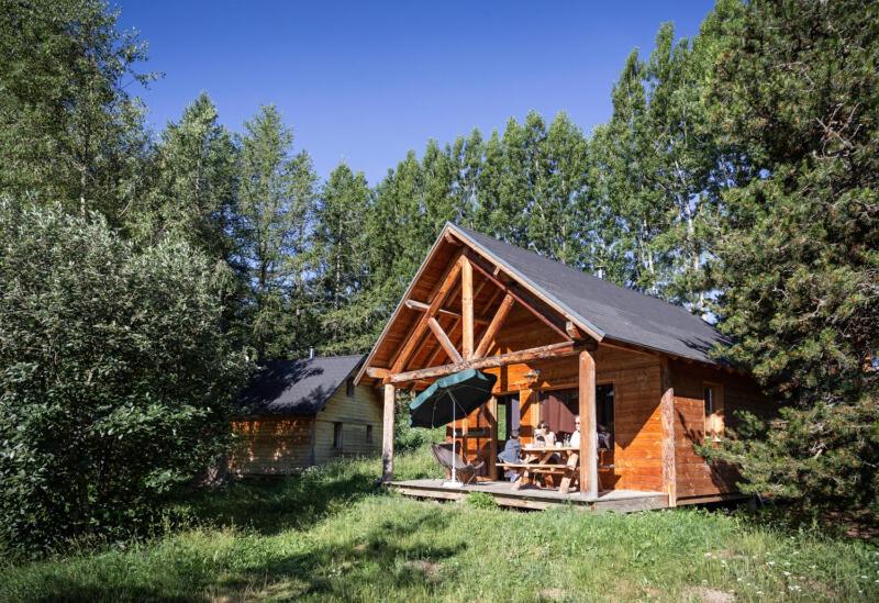 a log cabin in the middle of a field at Huttopia Font Romeu in Font-Romeu