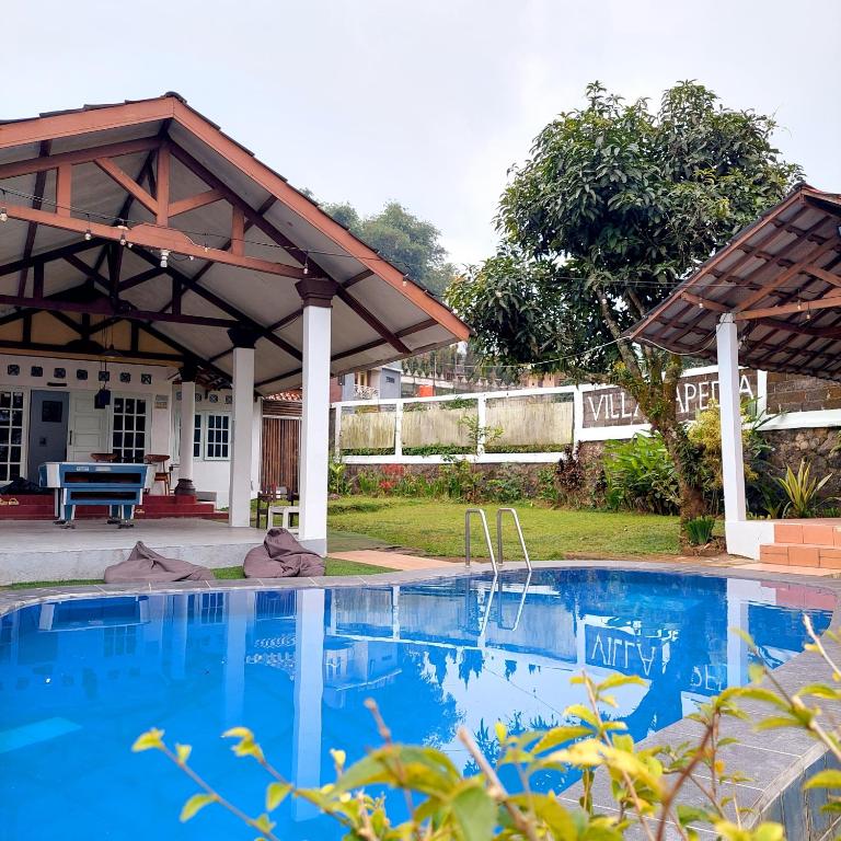 a house with a swimming pool and a pavilion at Villa Ananda 1, 3 KT Kolam Renang, Karaoke Biliar in Cisarua