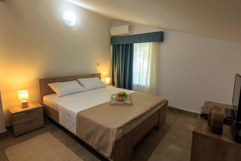 Łóżko lub łóżka w pokoju w obiekcie Riva Lux Apartments