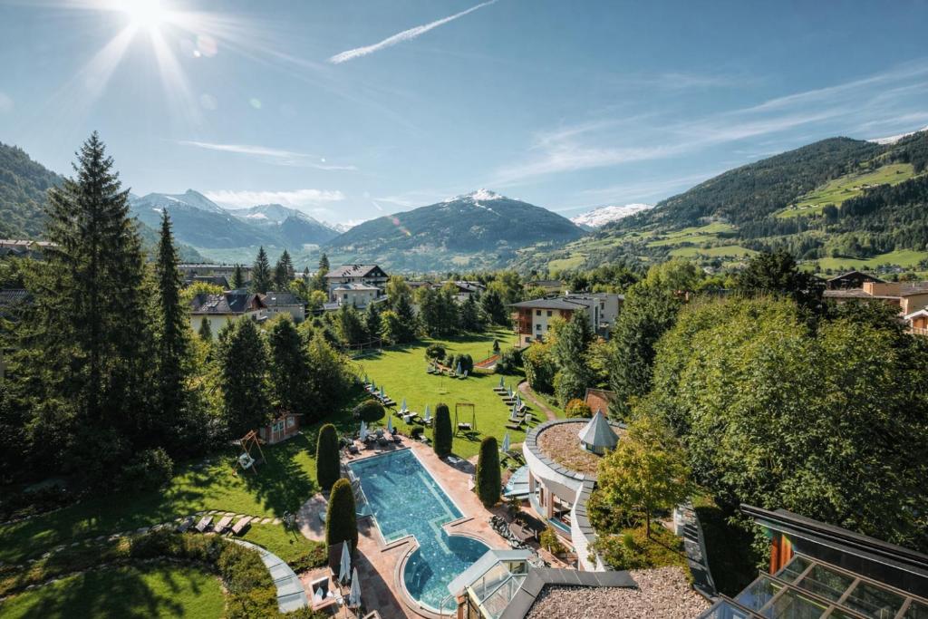 an aerial view of a resort with a swimming pool and mountains at Sendlhofer's in Bad Hofgastein