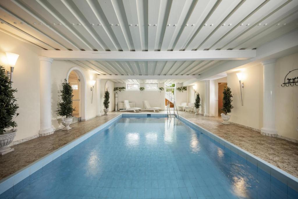 a large swimming pool in a building with a ceiling at Hotel Garni Keil in Kleinarl