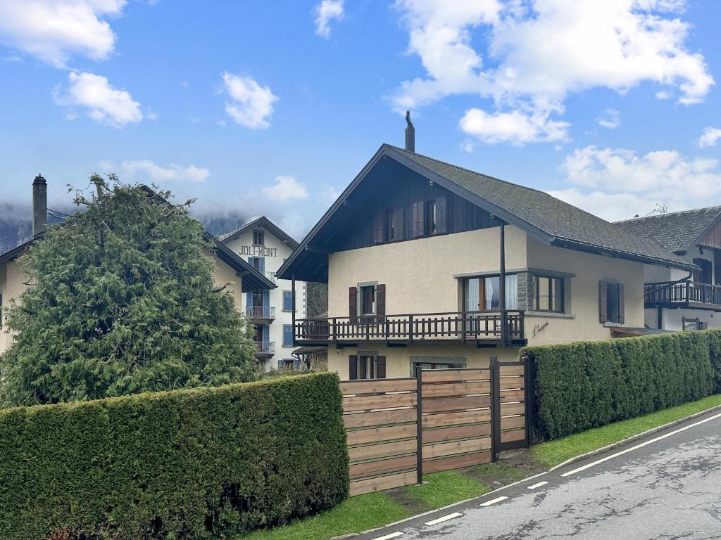 a large white house with a wooden fence at Chalet Familial l'Escapade - Les Marécottes - Swiss Alps in Les Marécottes