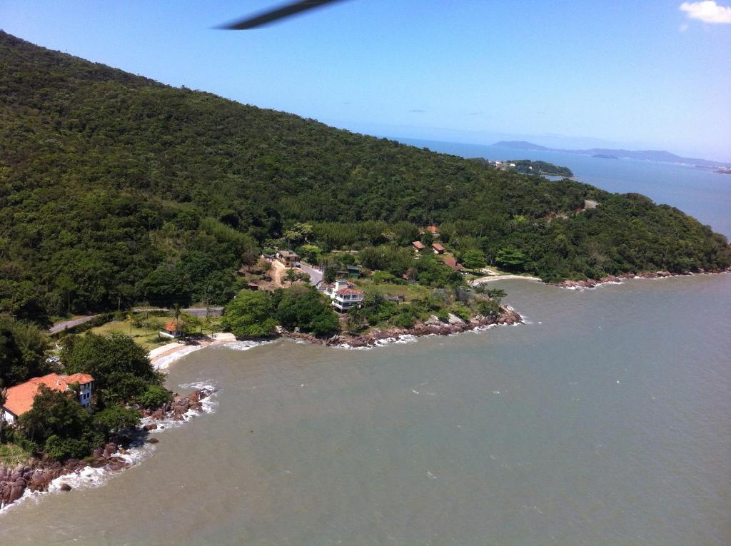 an aerial view of an island in the water at Praia Recanto das Pedras in Governador Celso Ramos