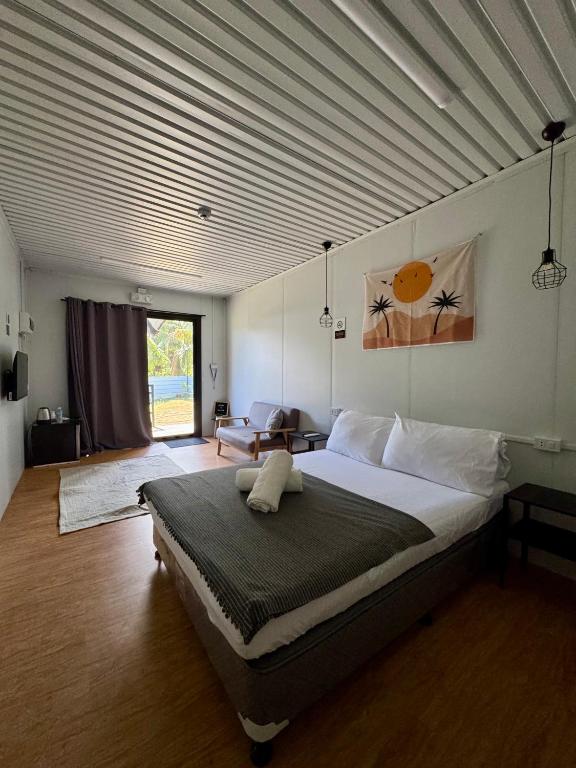 a bedroom with a large bed in a room at Siqui Pods in Siquijor