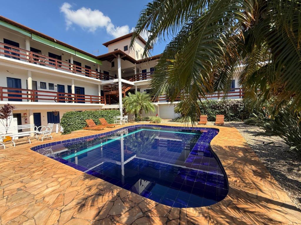 a swimming pool in front of a building at Pousada Dona Emilia in Brotas
