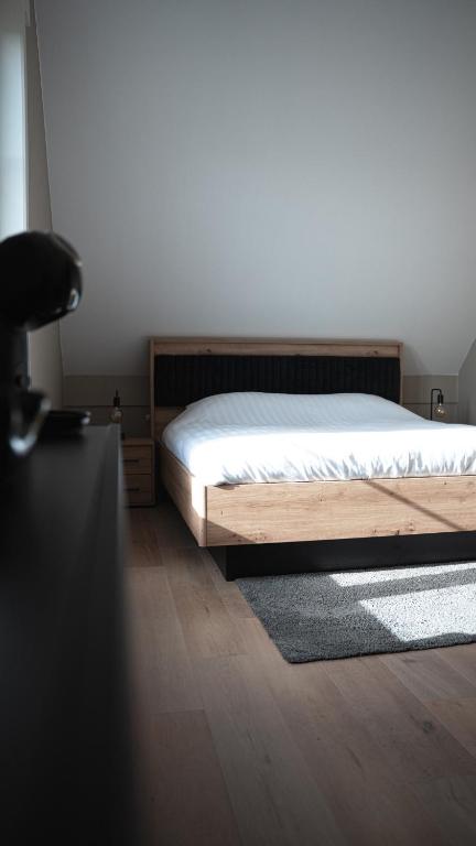 a bedroom with a bed and a desk with a chair at Maison Malo in As