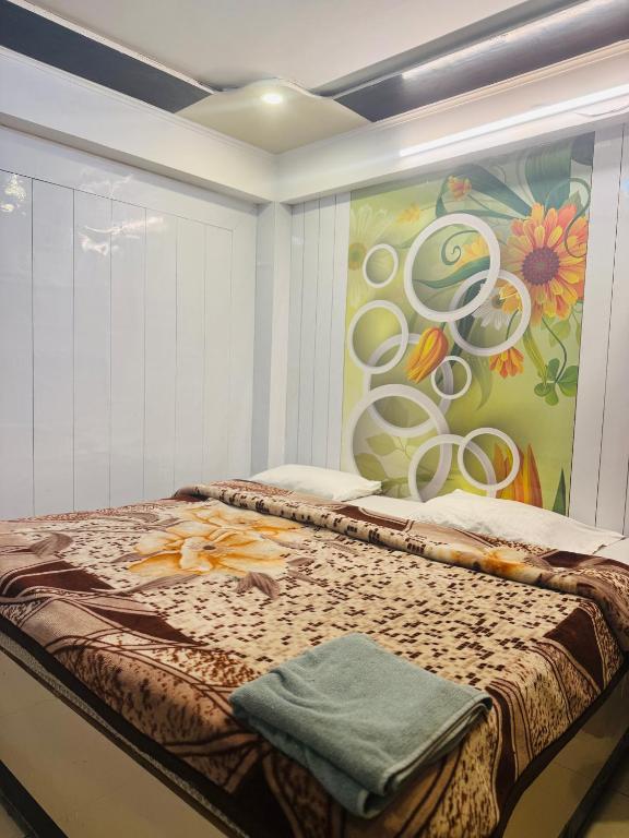a room with a bed with a painting on the wall at hotel sunshine in Nainital