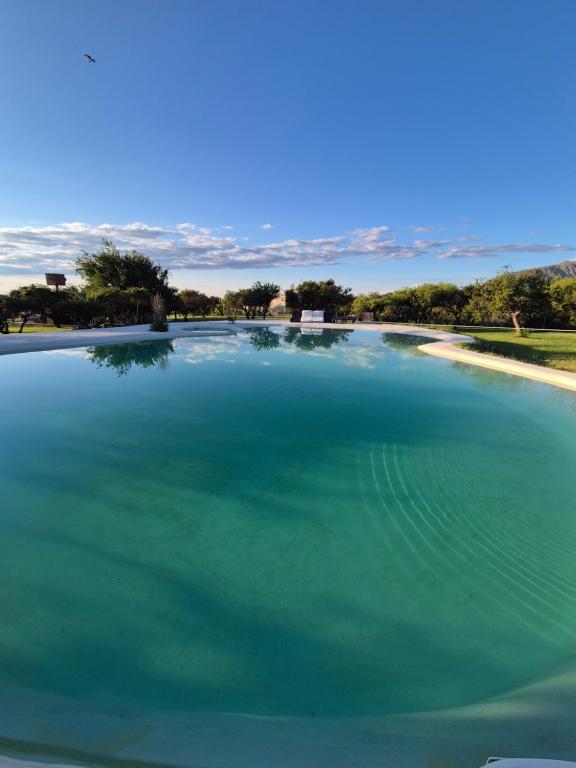 a large pool of water with trees in the background at Caranday in Cortaderas
