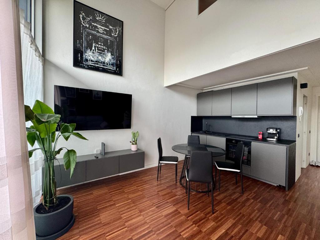 a kitchen and dining room with a table and chairs at Private Luxury Loft in Crescenzago