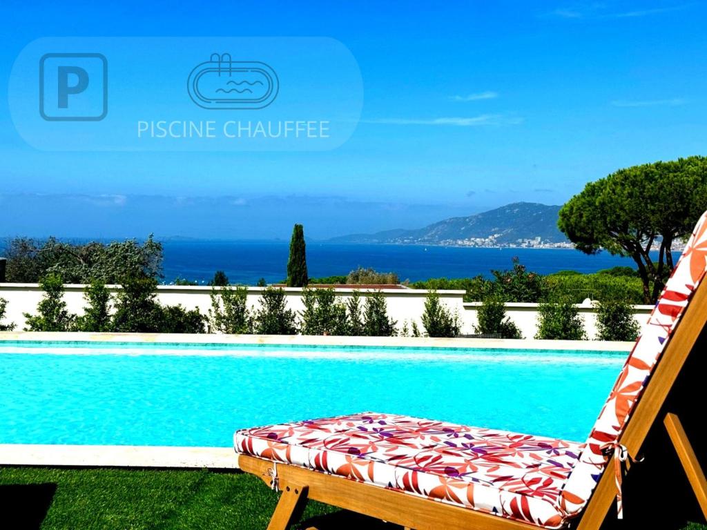 a bed sitting next to a swimming pool at Domaine LUMISTELLA in Porticcio