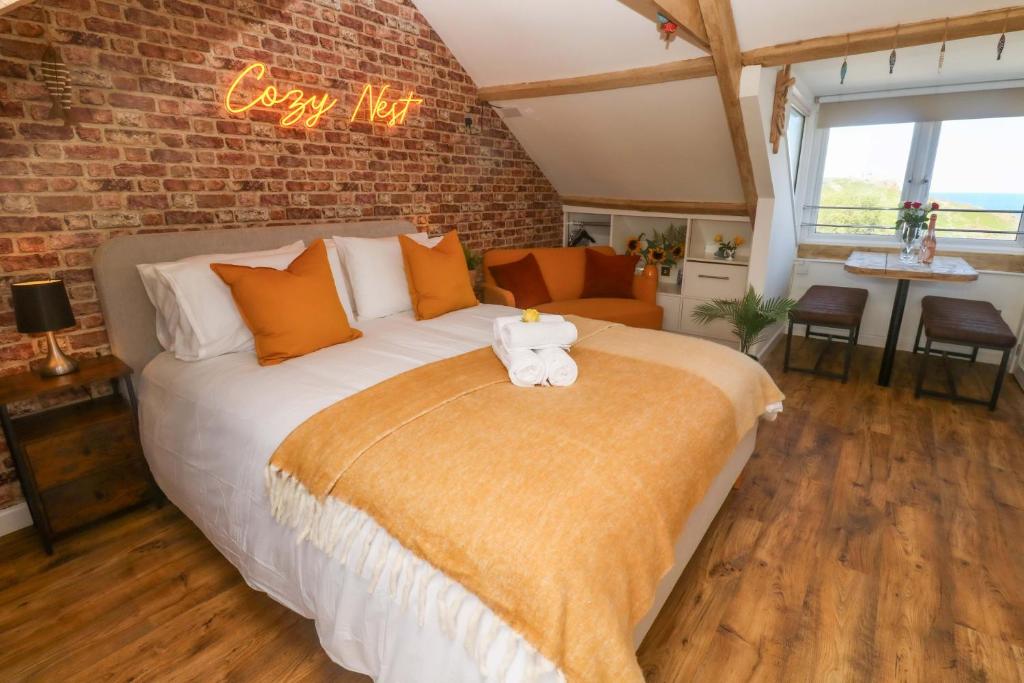 a bedroom with a bed with a teddy bear on it at Seagulls Nest in St Ives