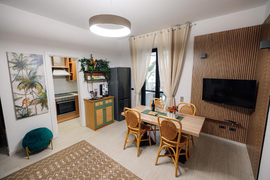 a kitchen and dining room with a table and chairs at Salento IBIZA in Gallipoli