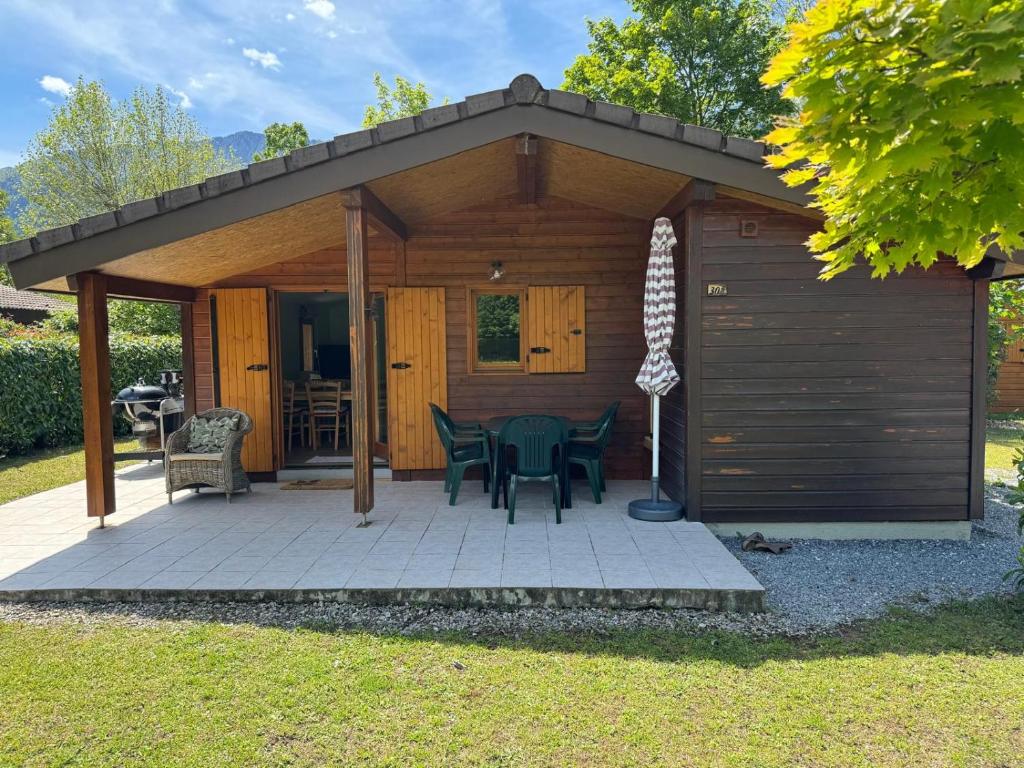 a pavilion with a table and chairs on a patio at Calm Waters in Doussard