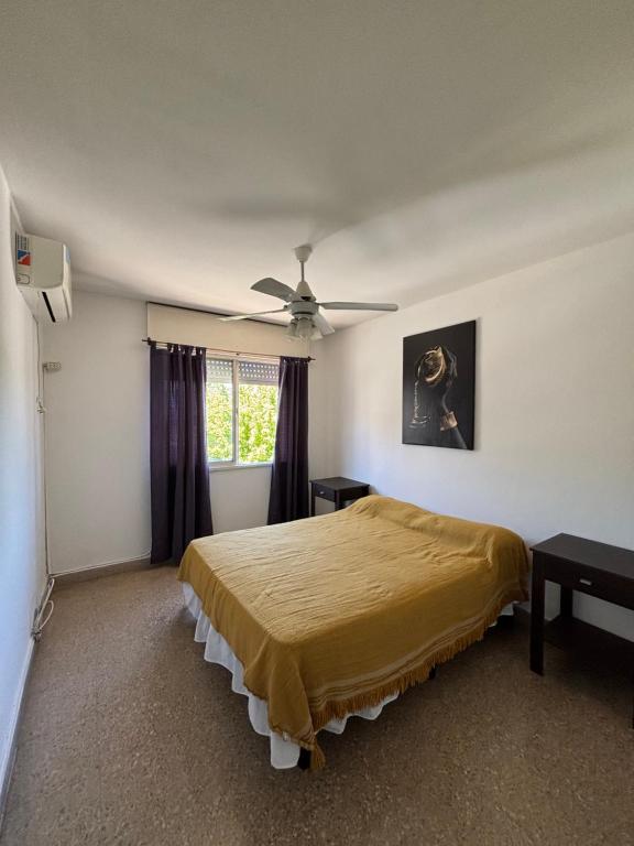 a bedroom with a bed and a ceiling fan at SIERRAS TRAVEL 2f in Villa Carlos Paz