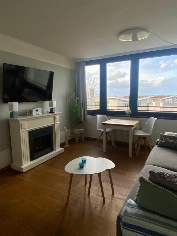 a living room with a couch and a table at Fewo GüNi Ostseeblick Wendtorf Marina Strand in Wendtorf