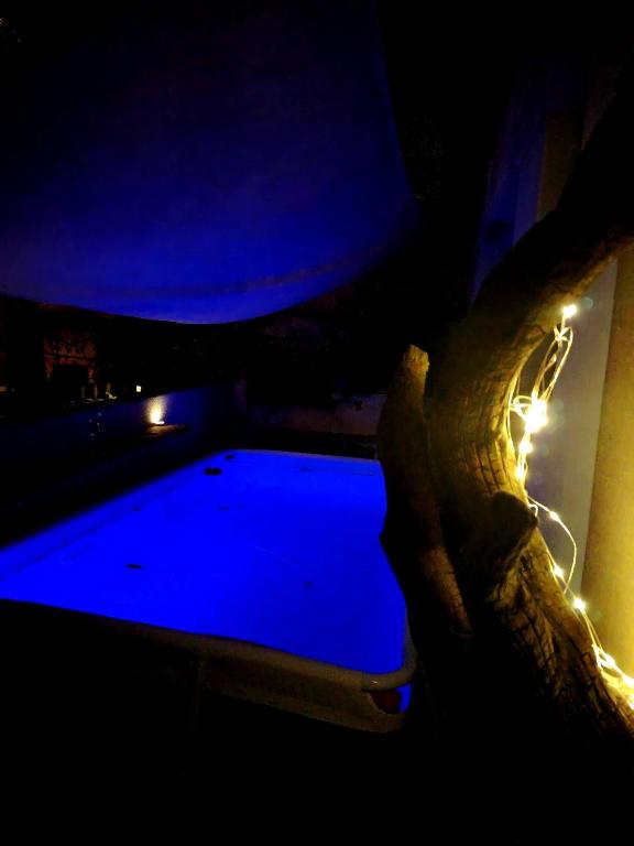 a swimming pool in a dark room with lights at Aqua B7 in Cavo
