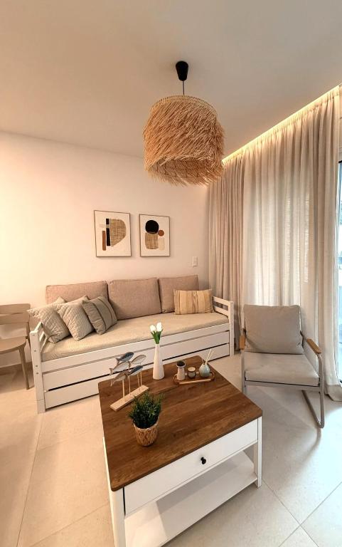 a living room with a couch and a table at Notos Blue in Tsoutsouros
