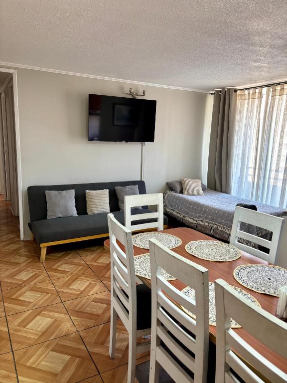 a living room with a couch and a table and chairs at Inversiones Inmobiliarias AYD in Santiago