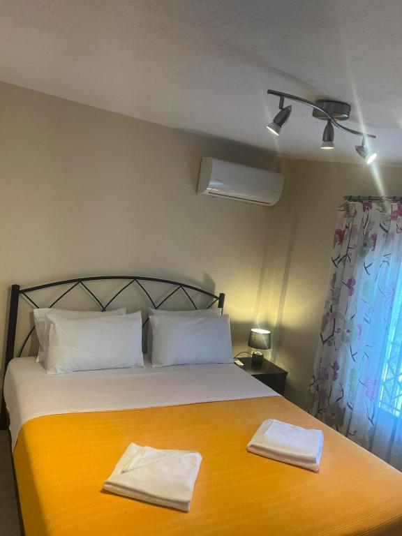 a bedroom with a bed with two towels on it at Villa Elli in Limenas