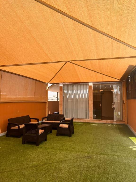a large tent with chairs and tables in a room at luxury rooftop apartment in Jeddah