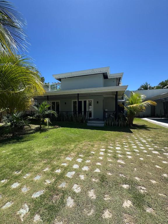 a house with a grass yard in front of it at Casa G in Bacong