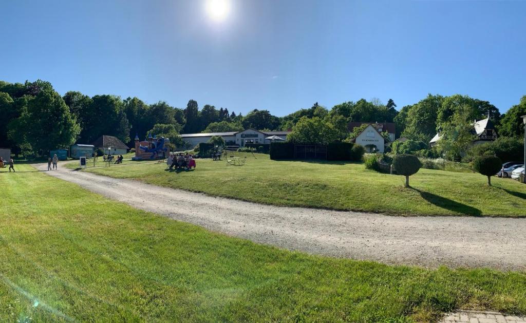 a gravel road in a field with people walking on it at Zum Schlossgarten in Ralswiek